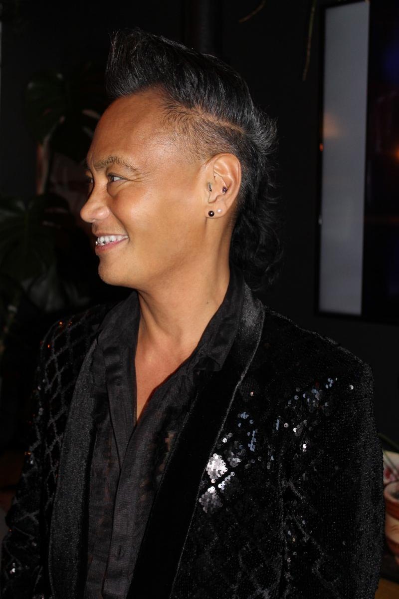 Portrait of a man in a sequined jacket at an evening event